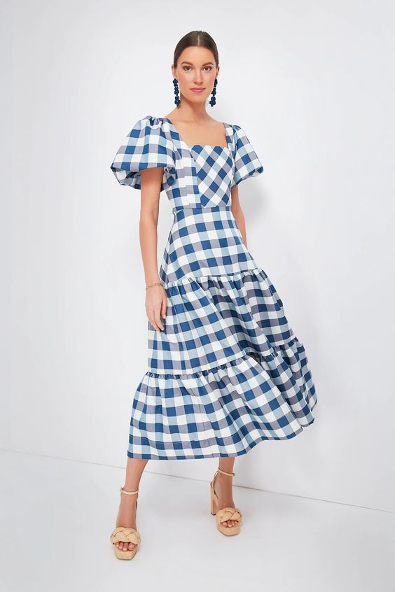 Woman wearing a Blue and white gingham dress. 