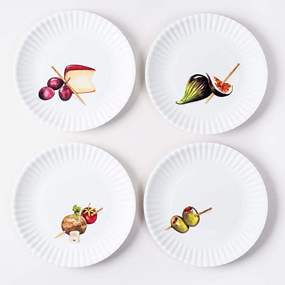 White plates with images of cheese, olives and figs in the corner. 
