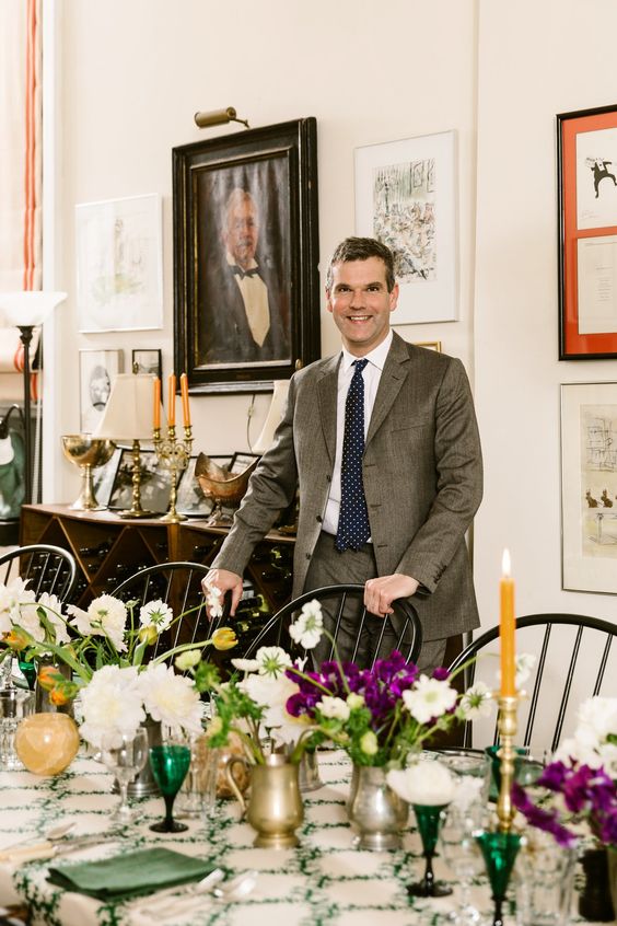 Ben Pentreath standing by a table. 