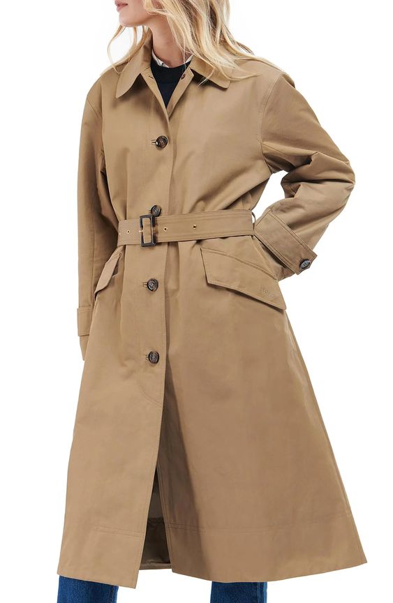 Woman wearing a tan trench coat. 