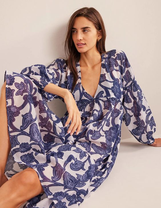 Blue and white Boden tunic dress on a seated woman. 
