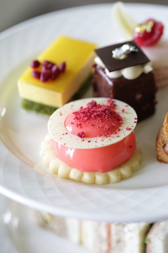 A tray of colorful mini cakes. 