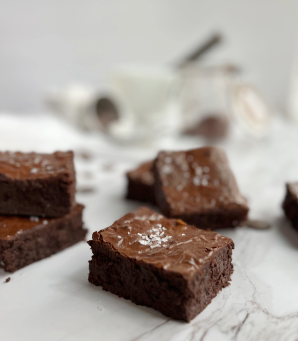 Brownies sprinkled with salt on a piece of marble. 