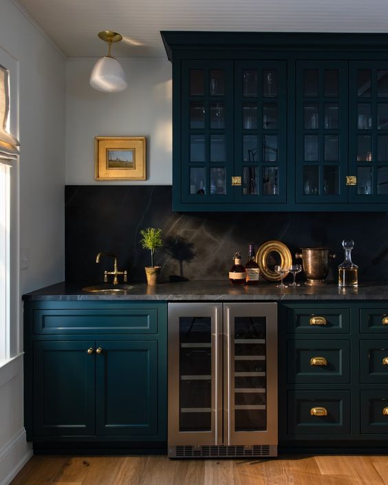 A dark moody blue wet bar. 