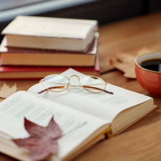 Fall books with leaves and tea.