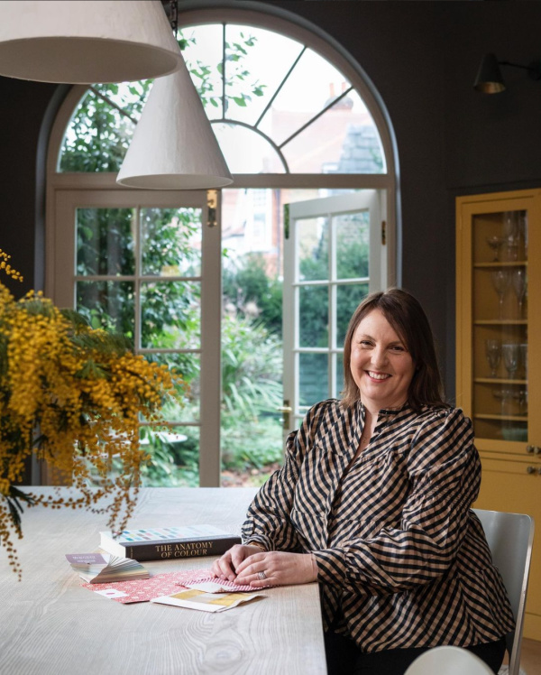 Woman seated at a table. 