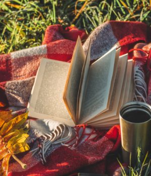 fall book coffee throw on the grass.