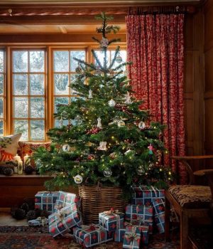 English Country Cottage Christmas decor with tartan plaid, fairy lights, holly, Christmas crackers, orange pomanders, garland and more.