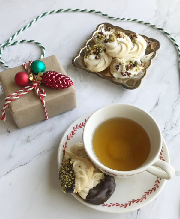 Viennese Whirl Cookies with white chocolate and a cup of tea.