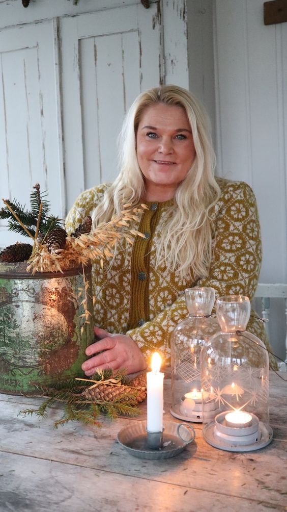 image of a woman with a tin bucket and a little tree and candles. 