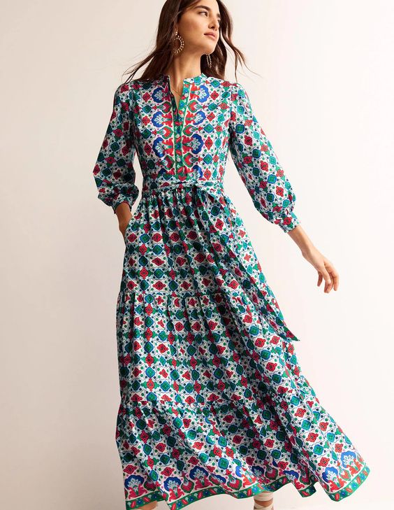 Woman wearing a colorful blue dress. 