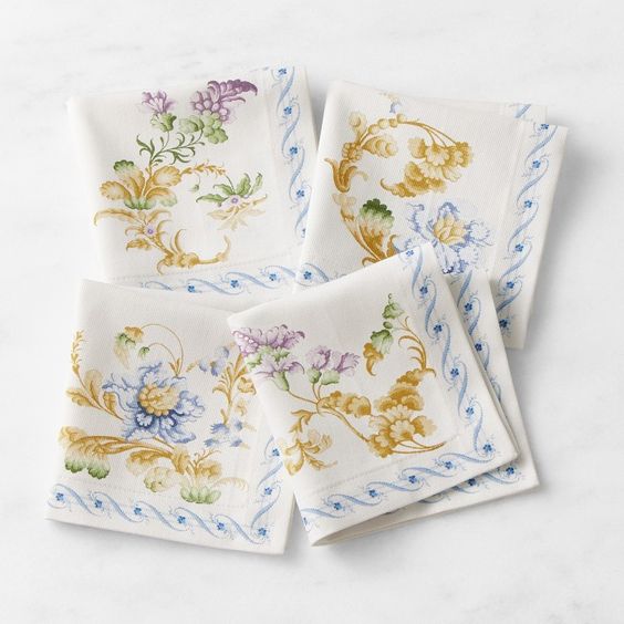 white napkins with blue swirls and yellow flowers. 