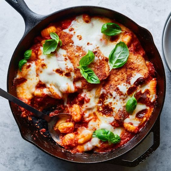 One pot chicken Parmesan in a black skillet.
