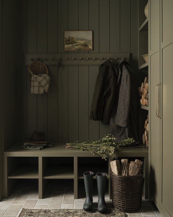 Tiffany Leigh Design, moody green mudroom with coats and wellie boots. 