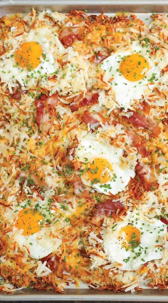 Sheet pan breakfast with eggs hash browns and bacon. 