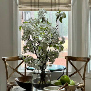 Pear Blossoms in a large jar on an island in the kitchen.