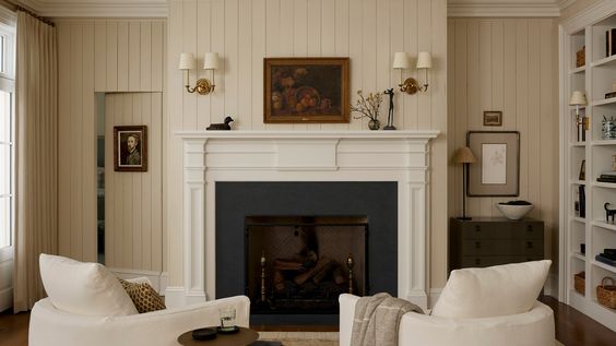 living room with off-white walls and furniture and a fireplace. 
