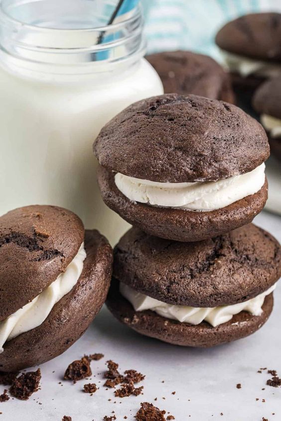 Whoopie pies o a stack with a quart of milk. 