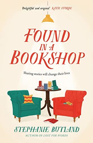 Found in a Bookshop book cover with a red and green chair and a round table between them. 