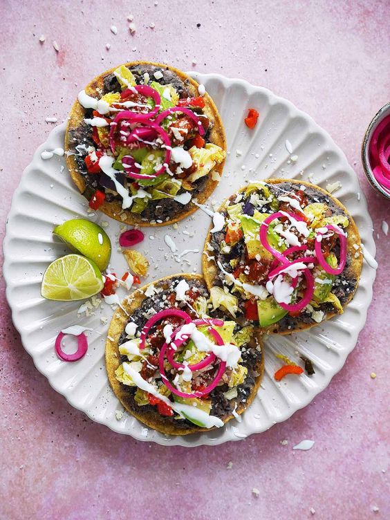 Black Bean Tostadas with homemade salsas, guacamole, lettuce and cheese.