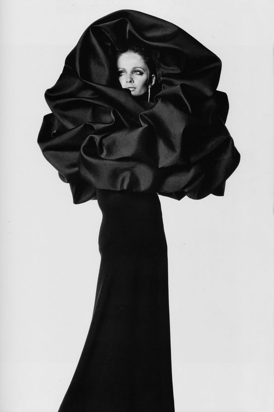 Cristóbal Balenciaga, woman in a black dress with an elaborate colar. 