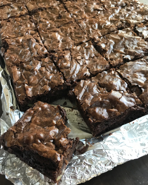 Pan of brownies, one with a bite. 