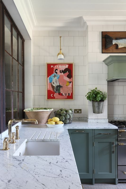 The Unexpected Red Theory, a red and pink painting in a jade blue kitchen. 