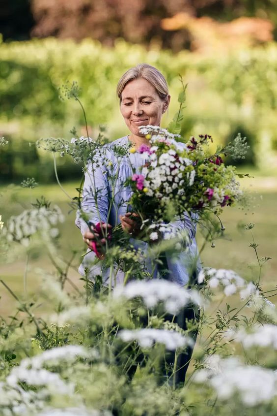 Woman standing in an English garden. 