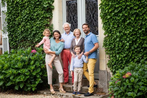 Four adults and two children standing on the steps of a chateau, Château de la Villedubois