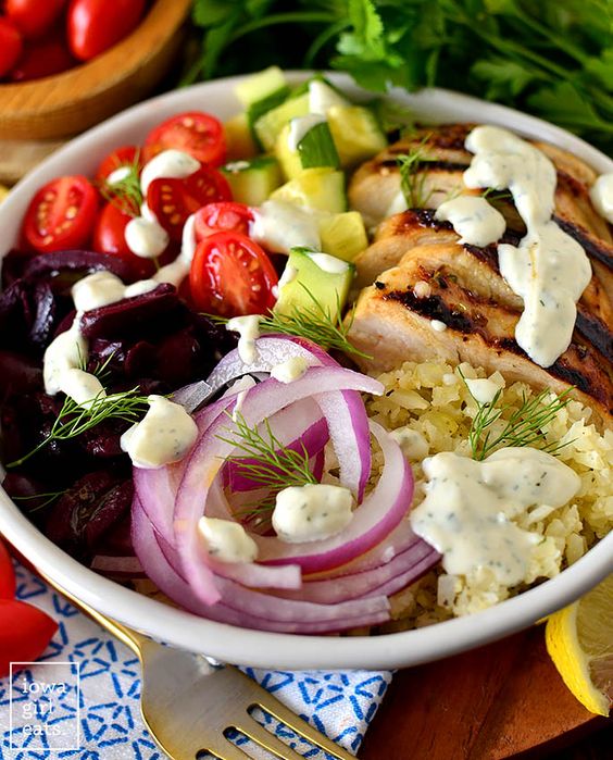 Greek Chicken salad Bowls with red onion, olives, cucumber and tomatoes. 