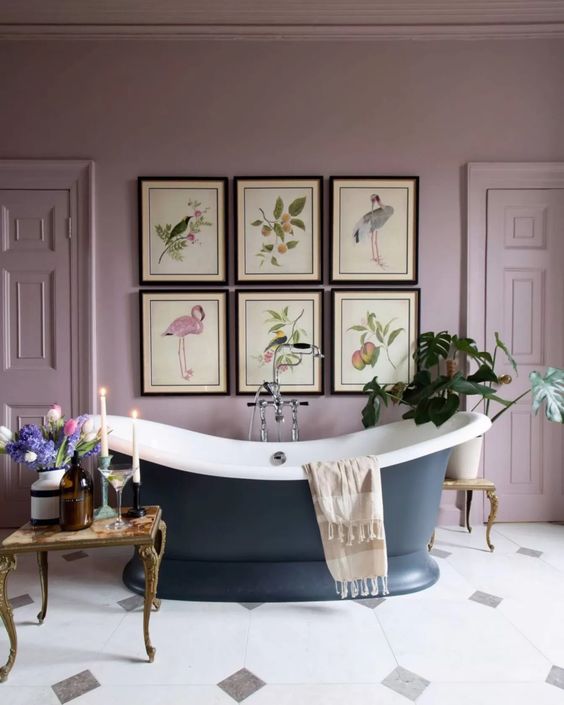 English cottage bathroom with pale purple walls and a blue tub. 
