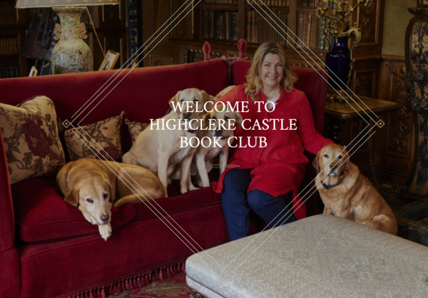 Highclere castle book club, woman sitting on a red velvet sofa with 4 golden retriever's. 