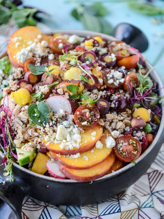 Summer grain bowl with peaches, cherries, grains and lettuce. 
