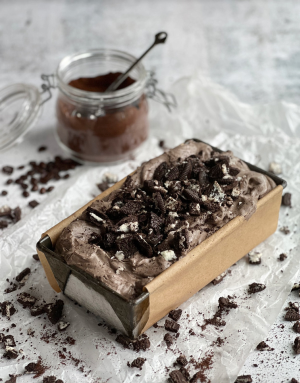 mocha cookies and cream ice creami in a loaf pan with a jar of espresso powder.