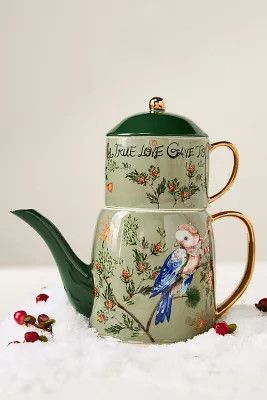 tae pot cup and lid green with a bird. 