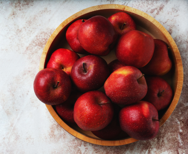 red apples in a wood bowl