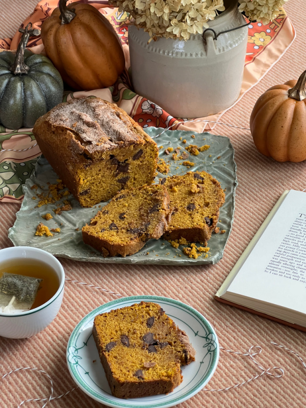 spice loaf cake, pumpkins a cup of tea and a book.