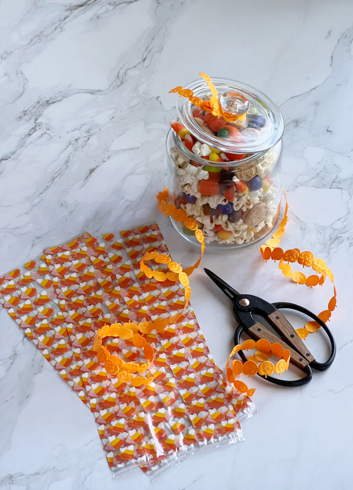 Fall snack mix in a glass jar and fall cellophane bags. 