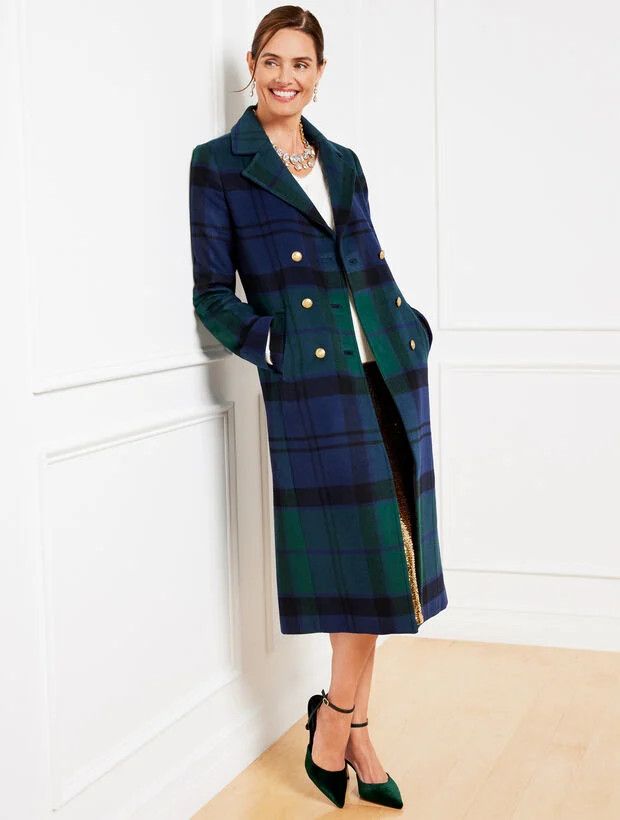Woman wearing a plaid coat.