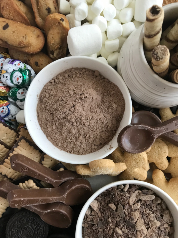 hot cocoa in a white bowl surrounded by marshmallows