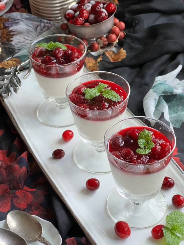 panna cotta with cranberry topping on a white tray