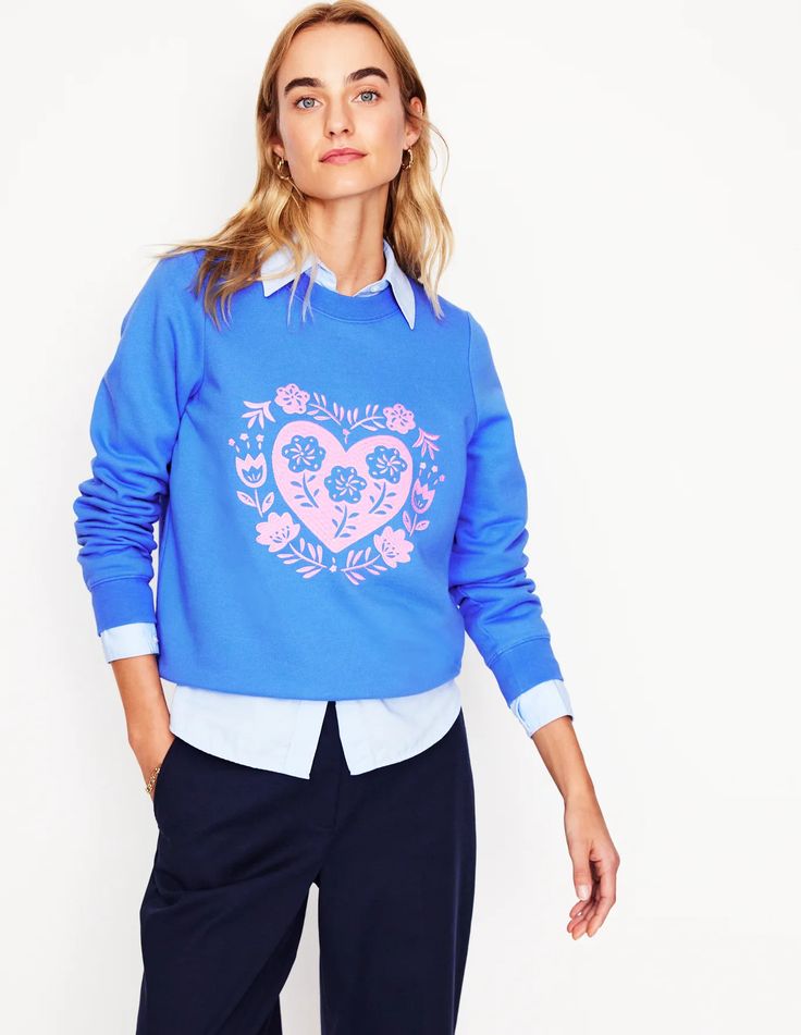 Pale blue and pink embroidered sweatshirt. 
