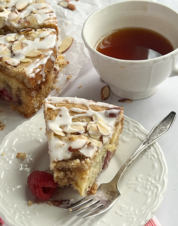 Raspberry Almond coffee cake with tea in a cup.