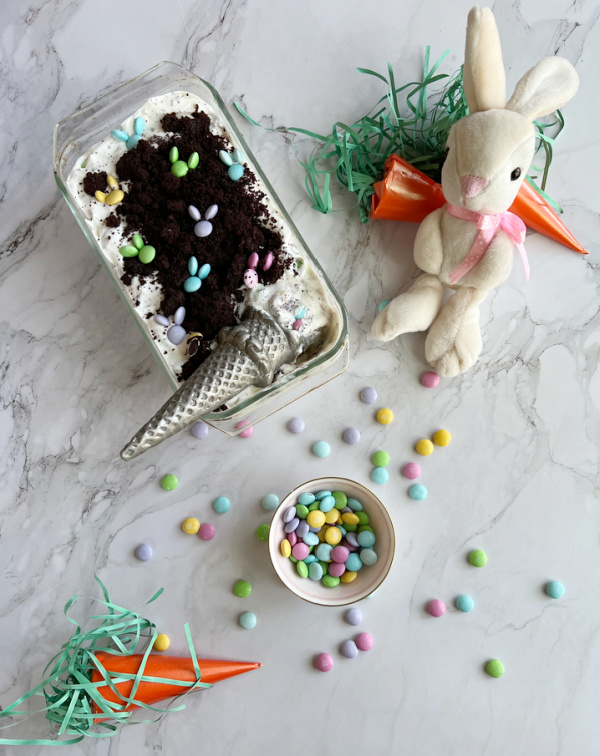 loaf pan of ice cream, orange paper carrots and a stuffed rabbit.