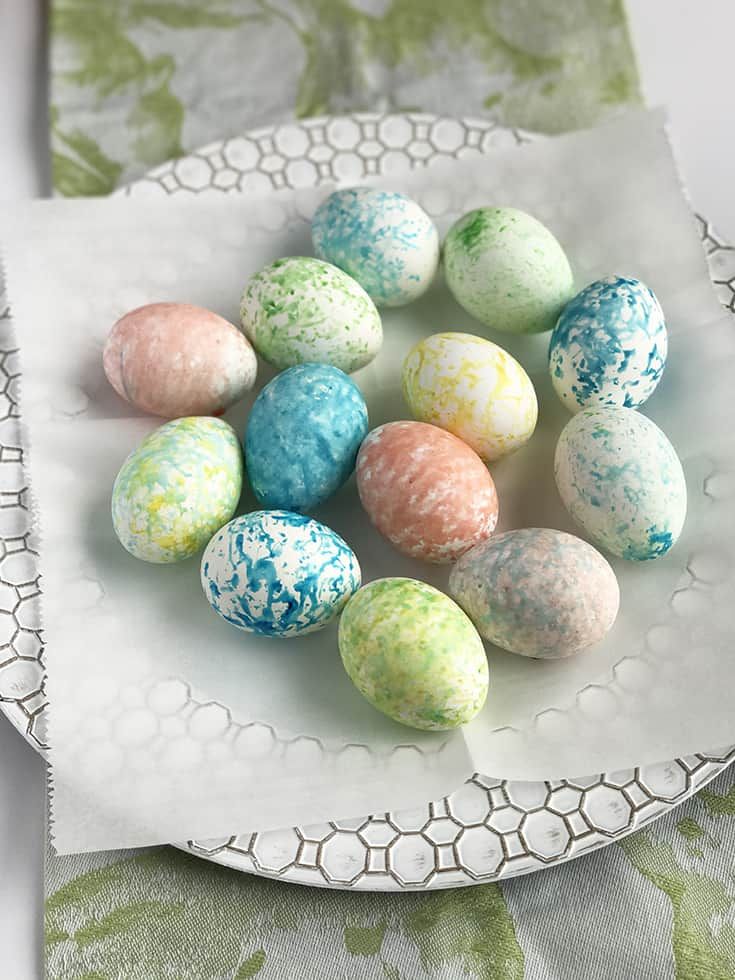 Speckled eggs in pastel colors. 