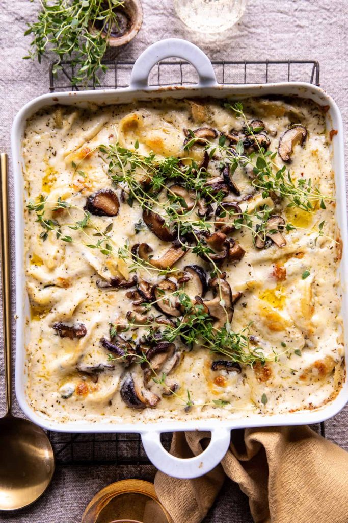 Creamy-White-Wine-Mushroom-Stuffed-Shells-1 in a white cast iron pan with handles. 