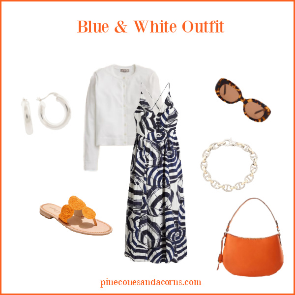 Blue and white outfit Fashion over 50, with a blue and white umbrella print dress, white sweater, orange sandals, orange bag and silver earrings and bracelet, as we'll as a pair of brown sunglasses. 