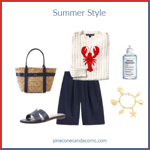 Fashion over 50 Summer Style with a white and red lobster sweater and blue shorts, sandals and bad, and a charm bracelet with shells.