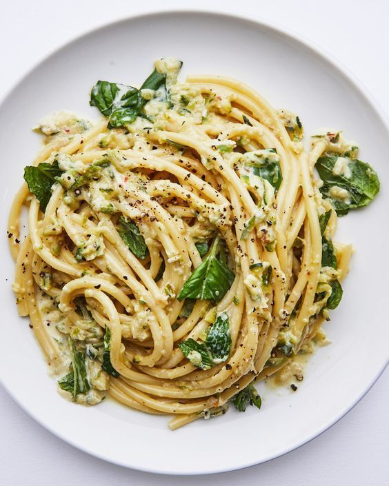 Zucchini lemon pasta in a white bowl.