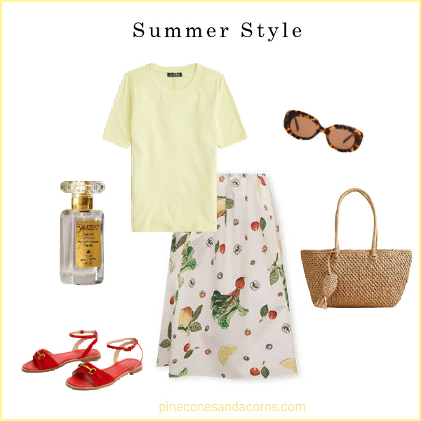 Fashion over 50 summer style printed skirt outfit, yellow t-shirt, red sandals, wicker bag, printed skirt with lemons and radish, perfume and sunglasses.